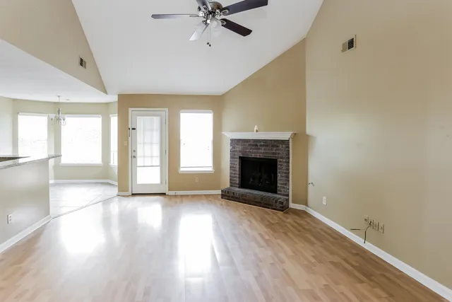 wooden floor fireplace and natural light in room