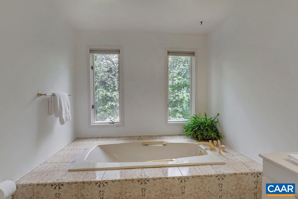 1903 Stillhouse Road Charlottesville, VA 22901 - Photo 21 of 44 a bath tub sitting in a bathroom next to a window