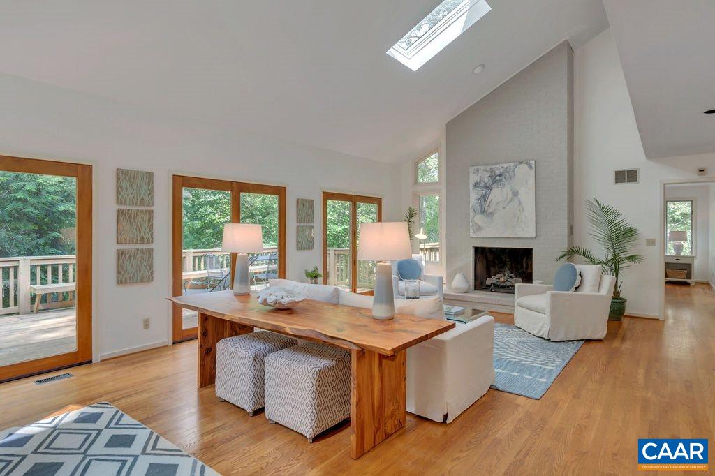 1903 Stillhouse Road Charlottesville, VA 22901 - Photo 5 of 44 a living room with fireplace furniture and a wooden floor