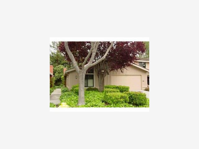a picture of a house with a small yard