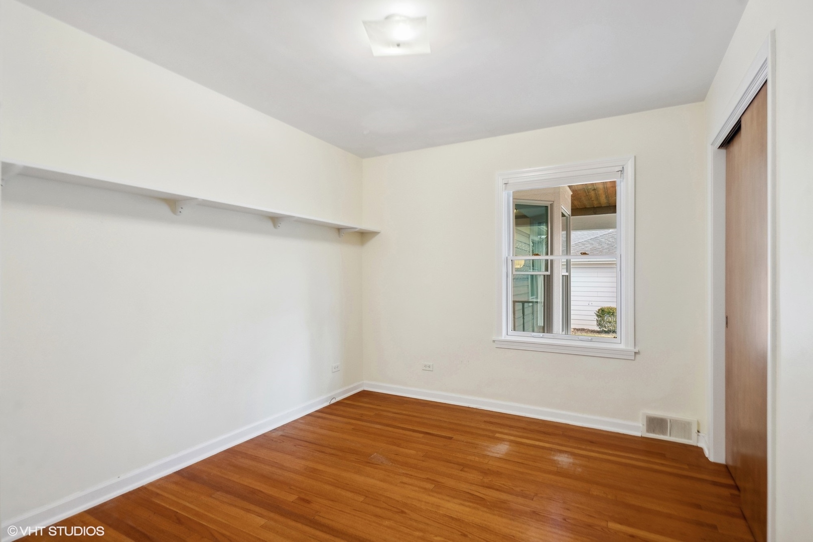 557 Riford Road Glen Ellyn, IL 60137 - Photo 15 of 25 an empty room with wooden floor and windows