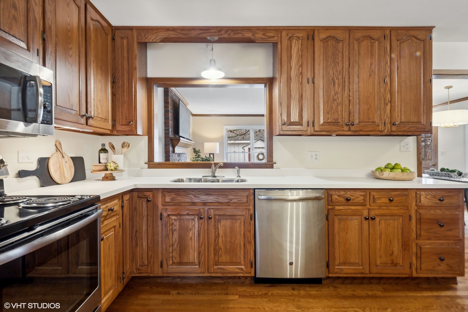 557 Riford Road Glen Ellyn, IL 60137 - Photo 7 of 25 a kitchen with stainless steel appliances granite countertop a sink and a stove
