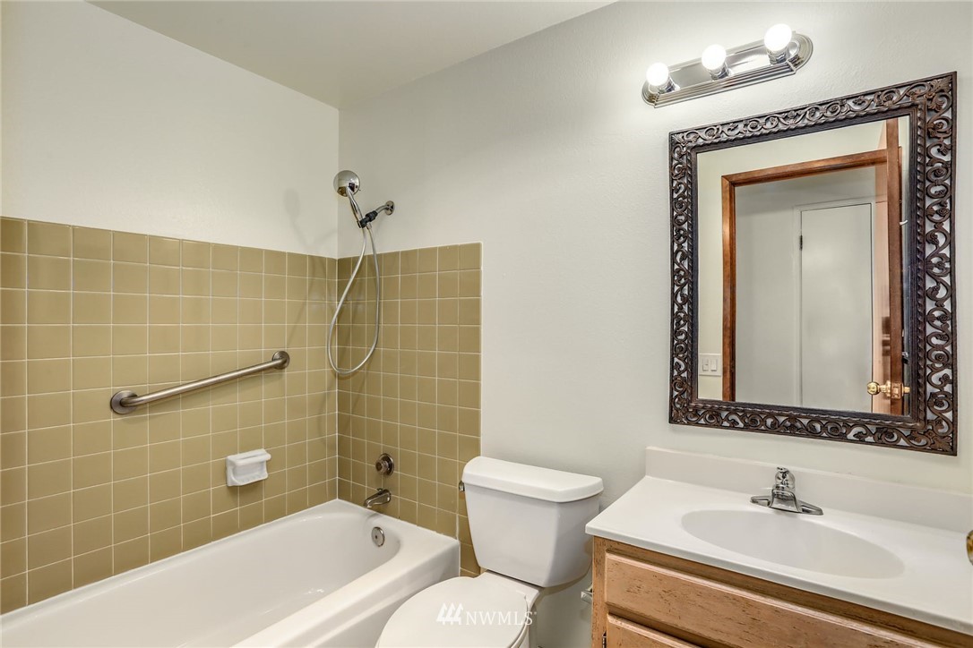 2020 Aberdeen Avenue Southeast Renton, WA 98055 - Photo 22 of 36 a bathroom with a toilet a sink and mirror