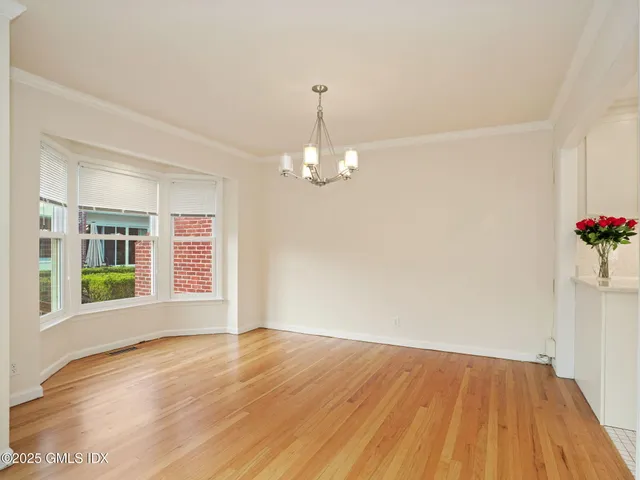 a kitchen with cabinets appliances a sink and a window