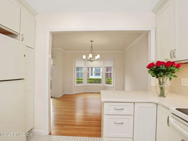 a bathroom with a toilet sink vanity and mirror