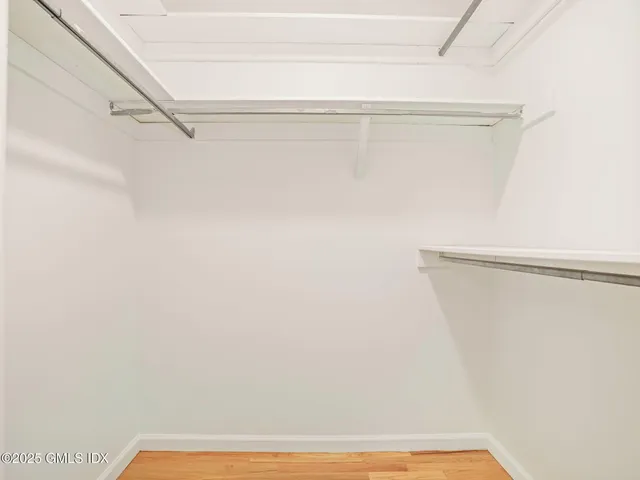 a bathroom with a toilet a sink a vanity and mirror