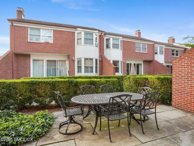 a view of a patio with table and chairs and potted plants