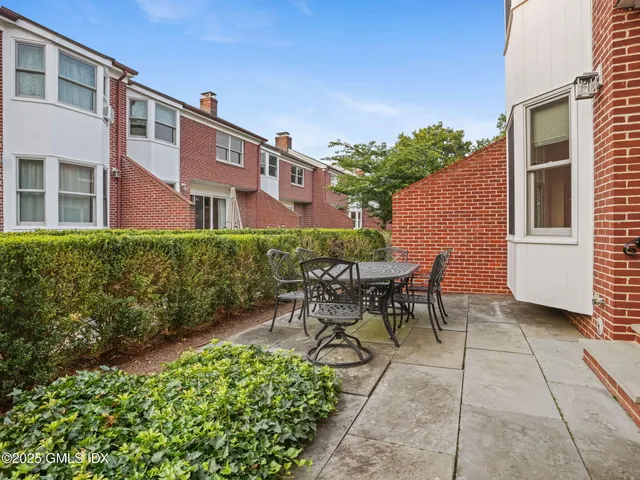 a view of a patio with a table and chairs