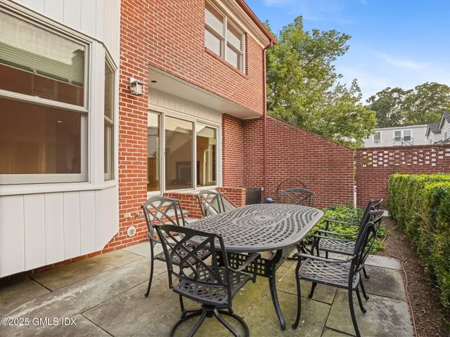 a front view of a house with outdoor seating