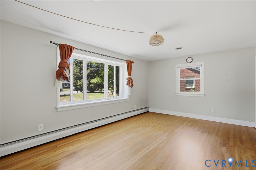 8210 Ireton Road Henrico, VA 23228 - Photo 5 of 36 a view of an empty room with wooden floor and a window