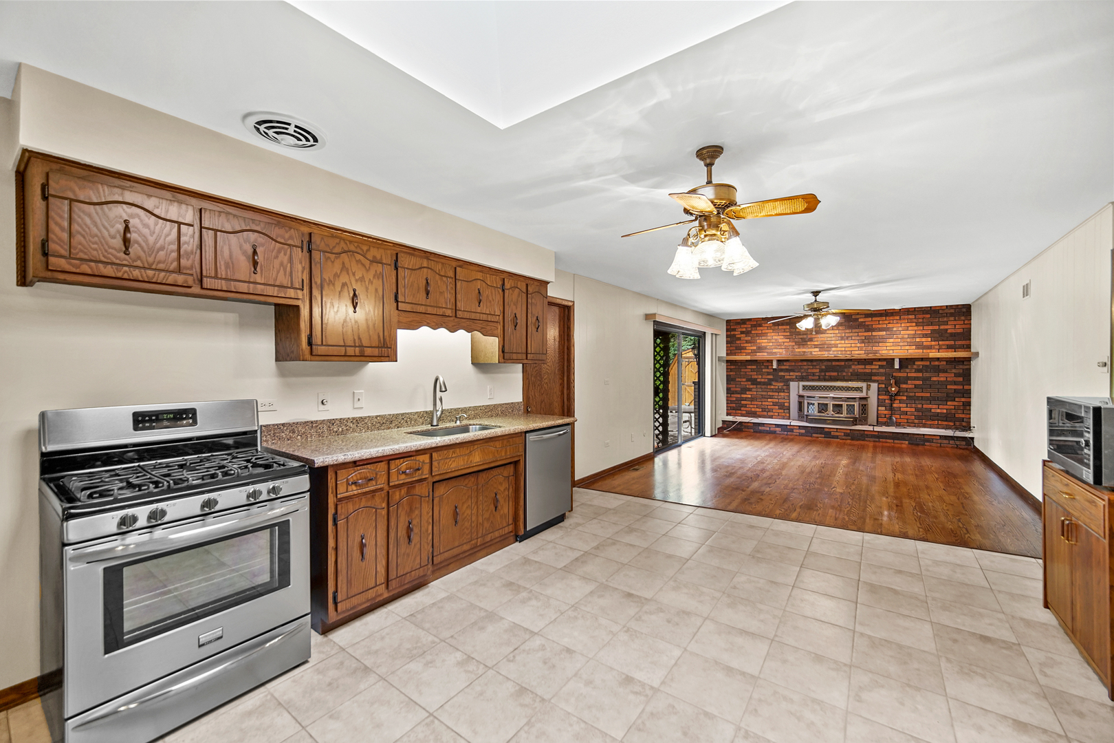 13105 Maple Road Mokena, IL 60448 - Photo 5 of 35 a kitchen with stainless steel appliances granite countertop a stove cabinets and entryway