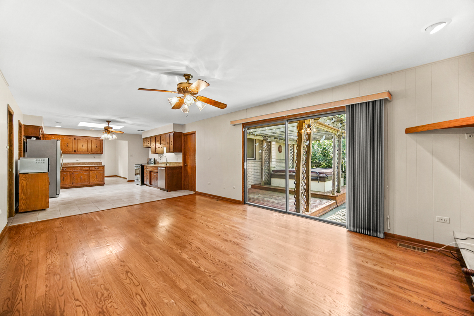 13105 Maple Road Mokena, IL 60448 - Photo 7 of 35 a view of an empty room with a window and wooden floor