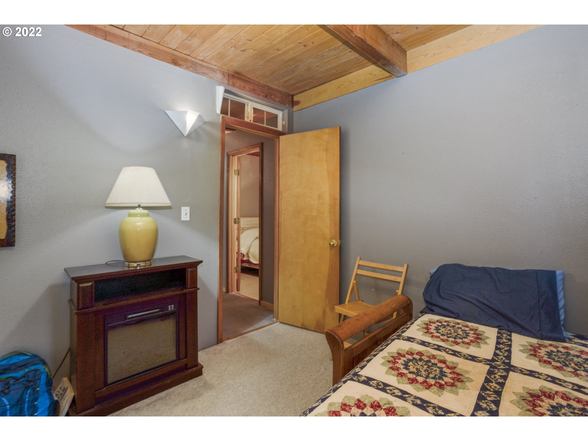 70 Moore Road White Salmon, WA 98672 - Photo 19 of 30 a bedroom with a bed and a lamp on dresser