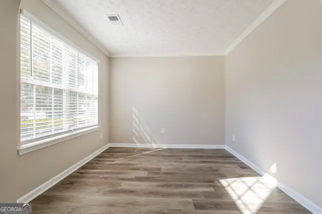 a view of wooden floor and windows in a room