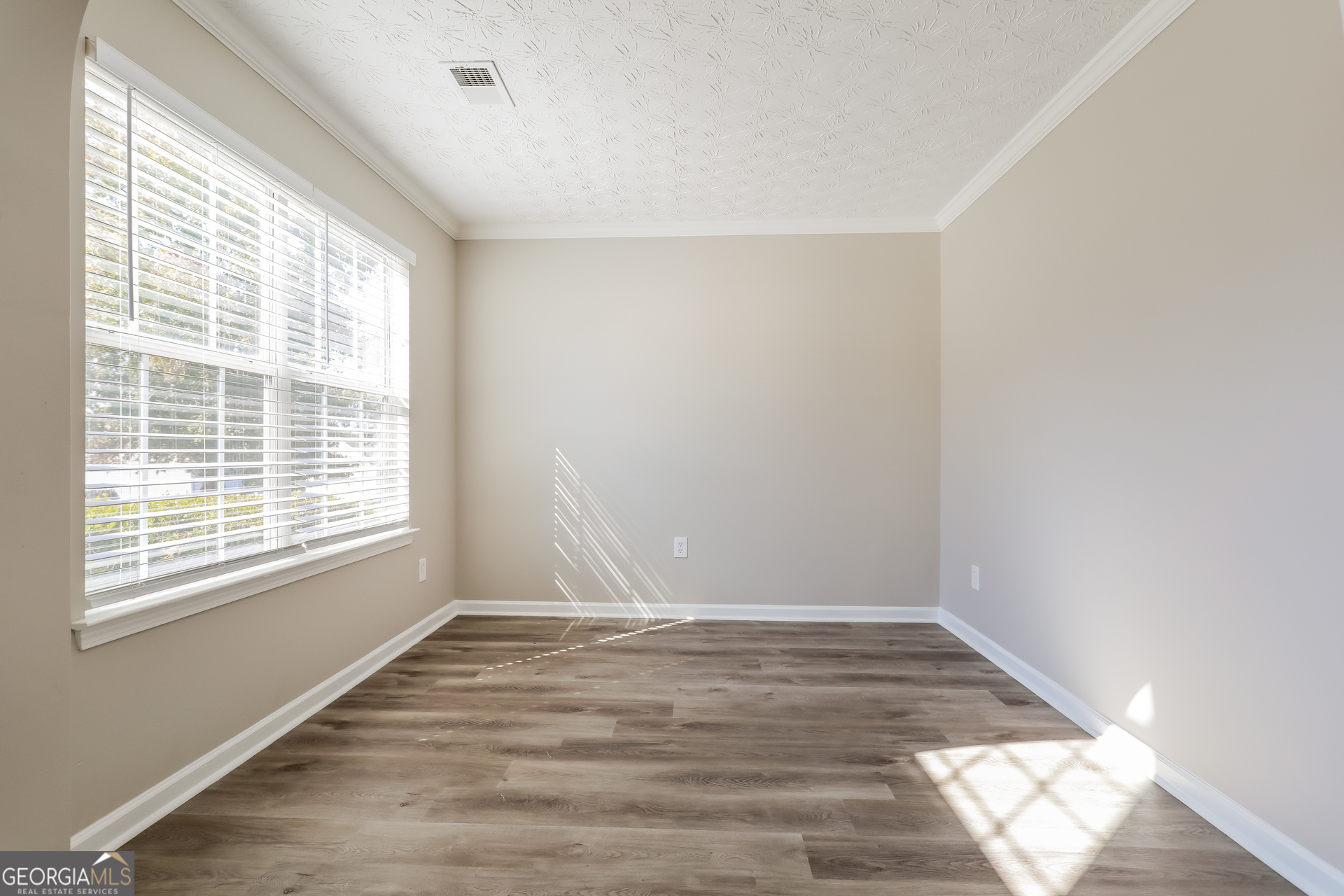 210 Heaton Pl Trail Covington, GA 30016 - Photo 12 of 17 a view of wooden floor and windows in a room