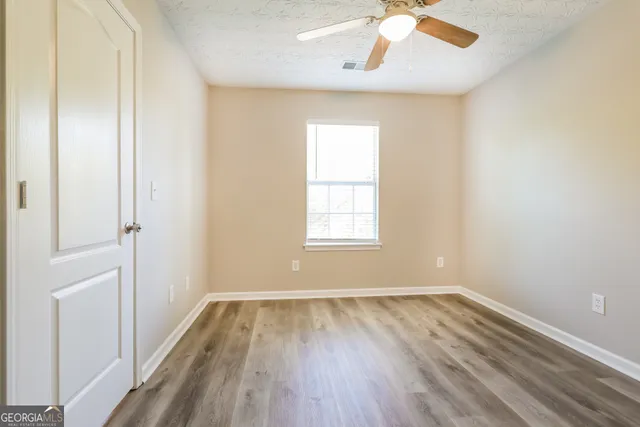 wooden floor in an empty room with a window