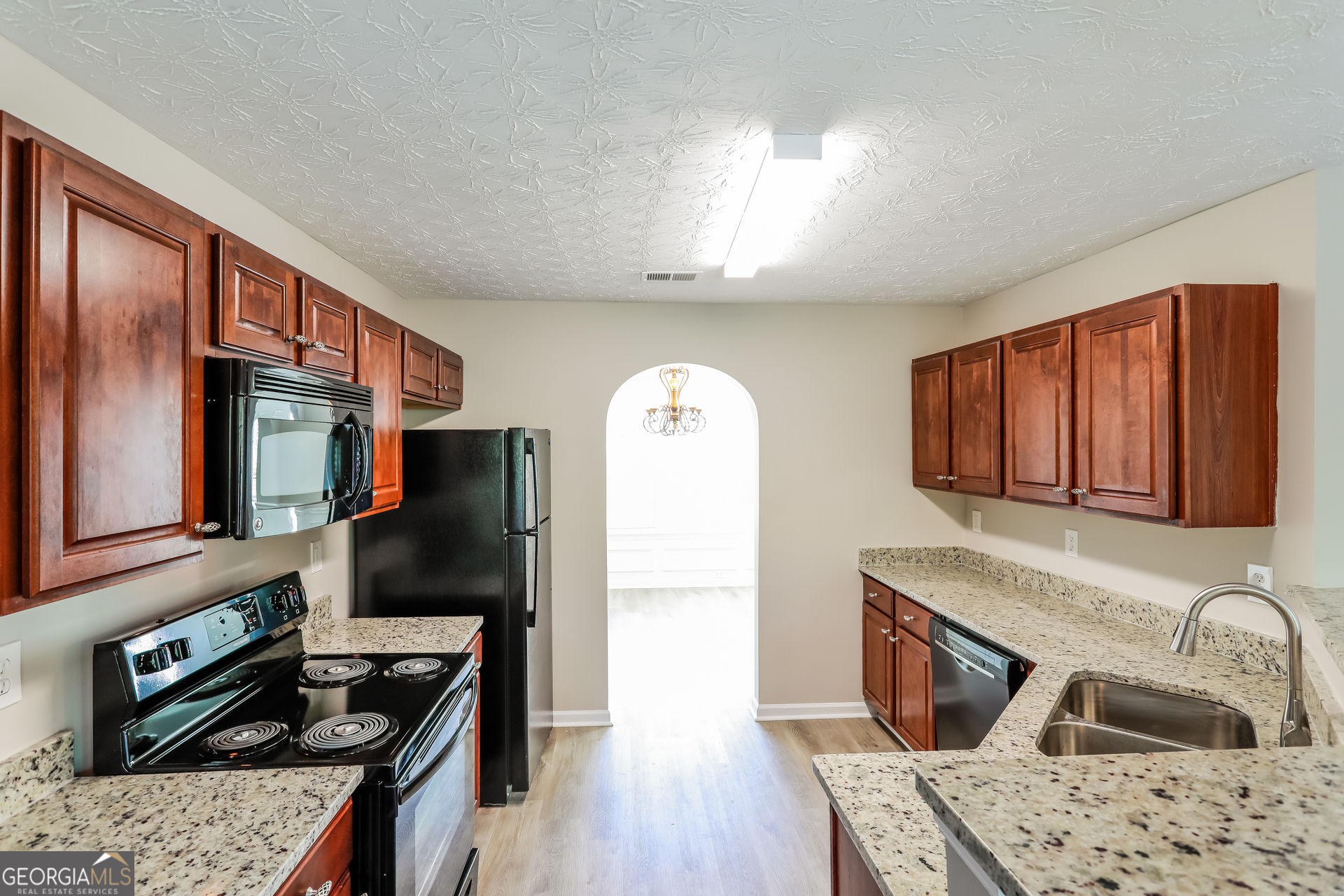 210 Heaton Pl Trail Covington, GA 30016 - Photo 5 of 17 a kitchen with stainless steel appliances granite countertop a sink stove and refrigerator