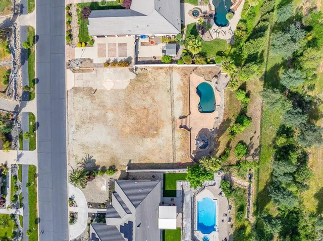 an aerial view of residential house with outdoor space and swimming pool