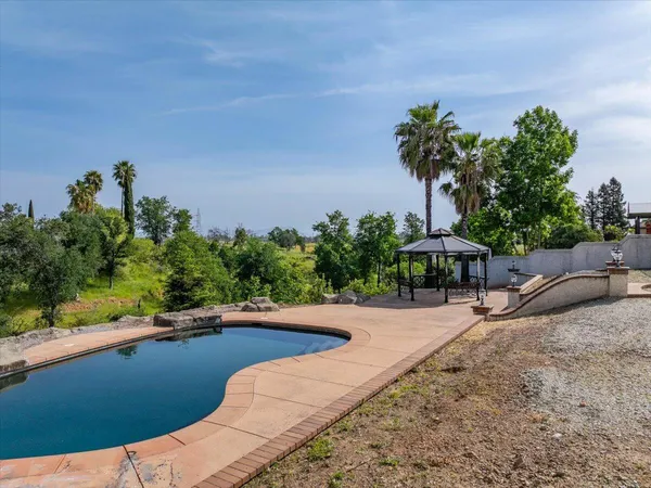 a view of a swimming pool with a yard