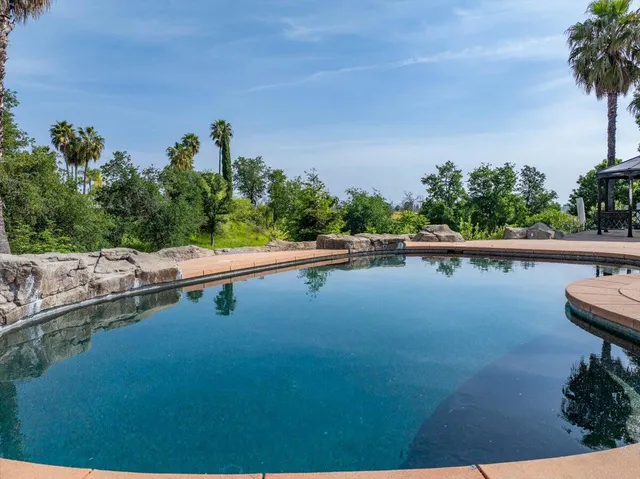 a view of a swimming pool with an outdoor seating