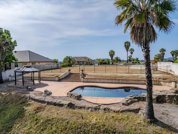 an aerial view of a house with outdoor space