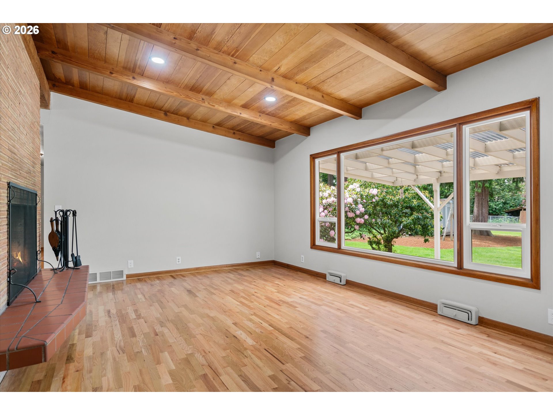 11345 Southwest 92nd Avenue Portland, OR 97223 - Photo 14 of 47 a view of an empty room with wooden floor and a window