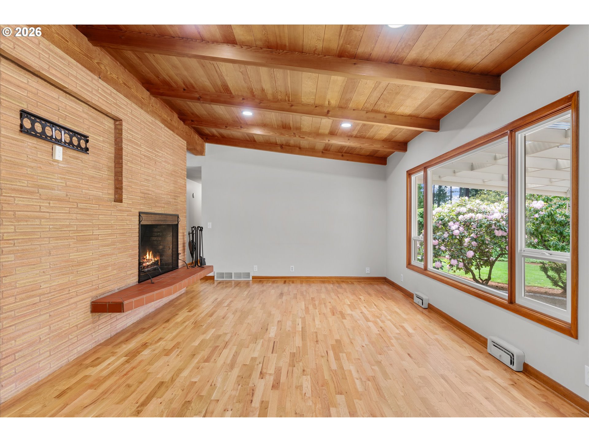 11345 Southwest 92nd Avenue Portland, OR 97223 - Photo 16 of 47 a view of empty room with wooden floor and fireplace