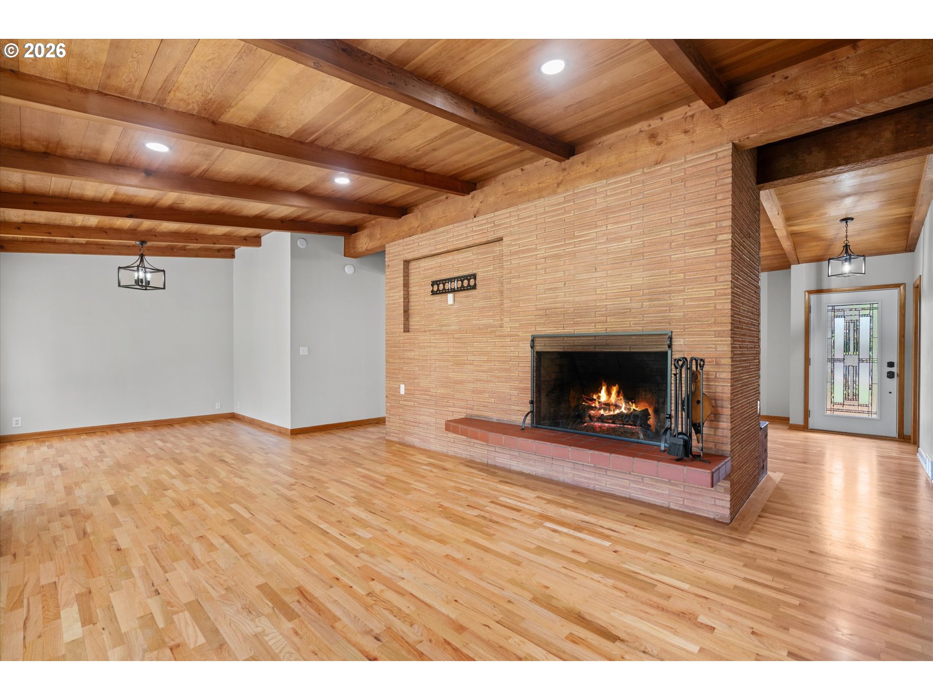 11345 Southwest 92nd Avenue Portland, OR 97223 - Photo 19 of 47 a view of empty room with wooden floor and fireplace