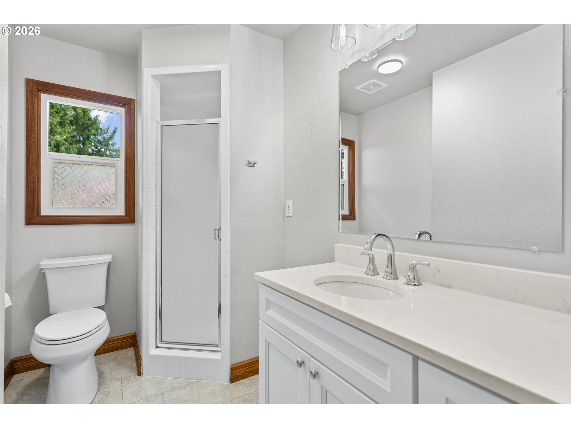 11345 Southwest 92nd Avenue Portland, OR 97223 - Photo 22 of 47 a bathroom with a toilet a sink a mirror and a window