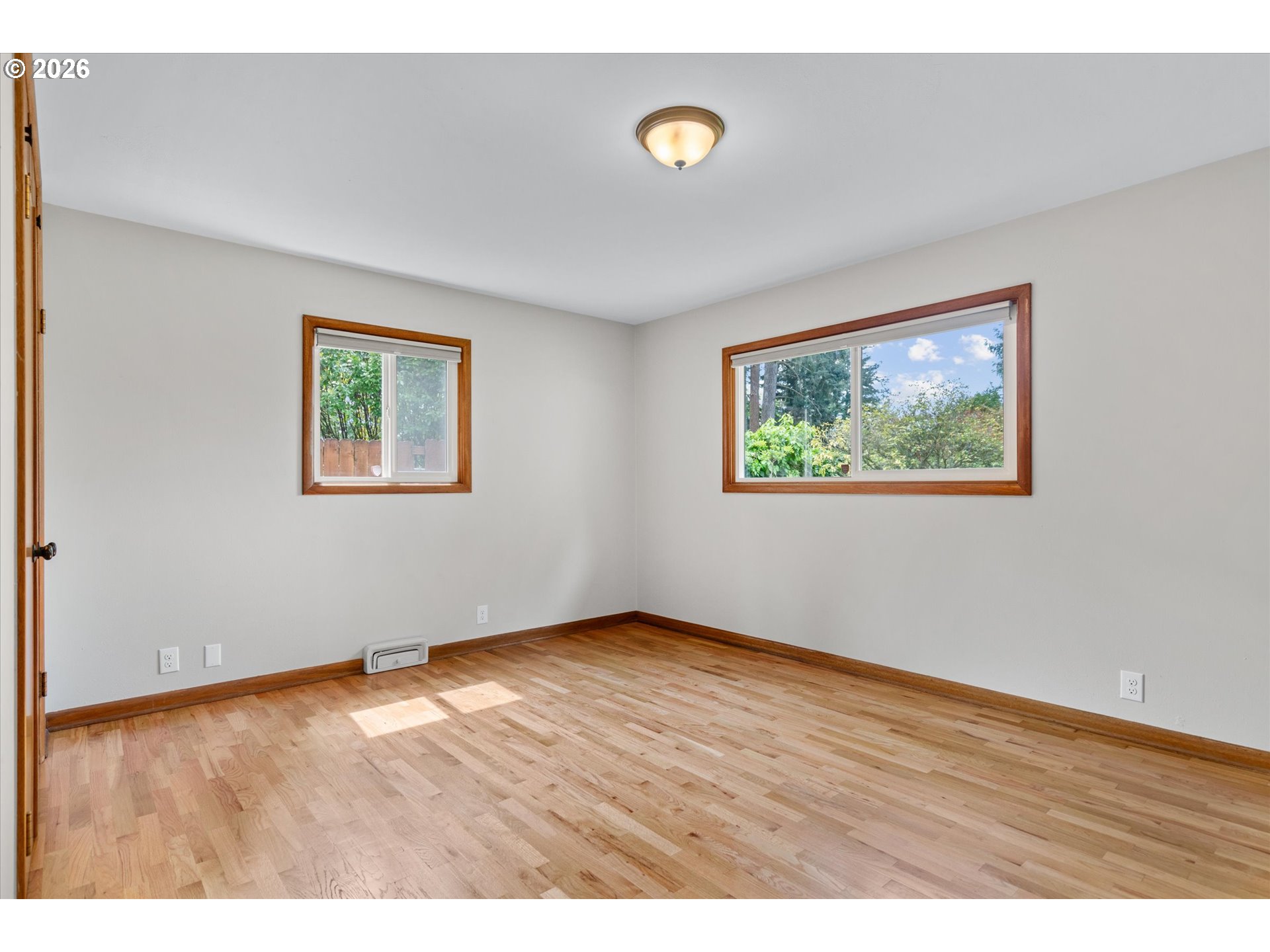 11345 Southwest 92nd Avenue Portland, OR 97223 - Photo 26 of 47 an empty room with wooden floor and windows