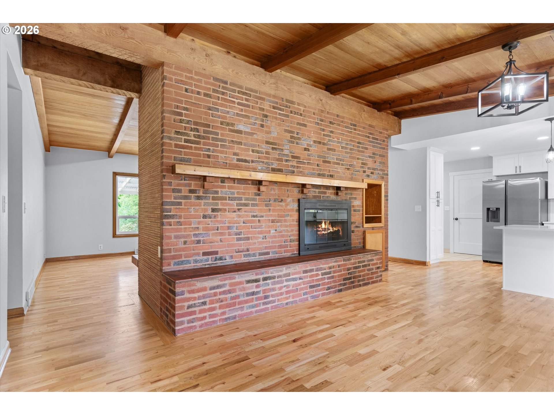 11345 Southwest 92nd Avenue Portland, OR 97223 - Photo 4 of 47 a view of empty room with wooden floor and fireplace