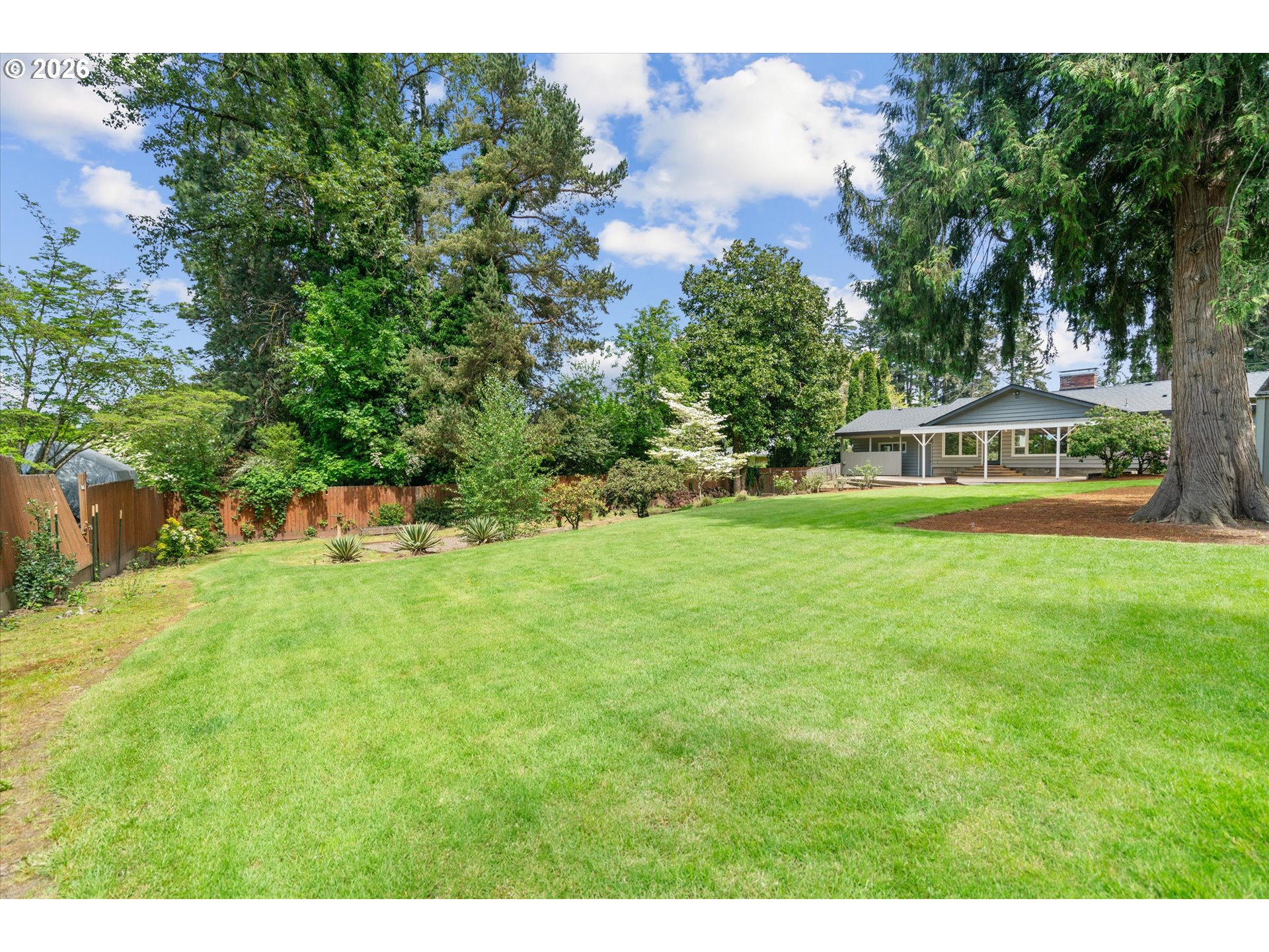 11345 Southwest 92nd Avenue Portland, OR 97223 - Photo 43 of 47 a view of a house with a big yard and large trees