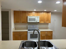 2025 Lavers Circle, Unit D207 Delray Beach, FL 33444 - Photo 4 of 12 a kitchen with a sink and a refrigerator