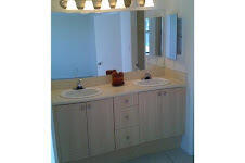 2025 Lavers Circle, Unit D207 Delray Beach, FL 33444 - Photo 6 of 12 a bathroom with a sink and a mirror