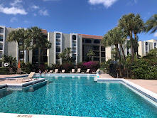 2025 Lavers Circle, Unit D207 Delray Beach, FL 33444 - Photo 8 of 12 a view of a house with backyard porch and sitting area