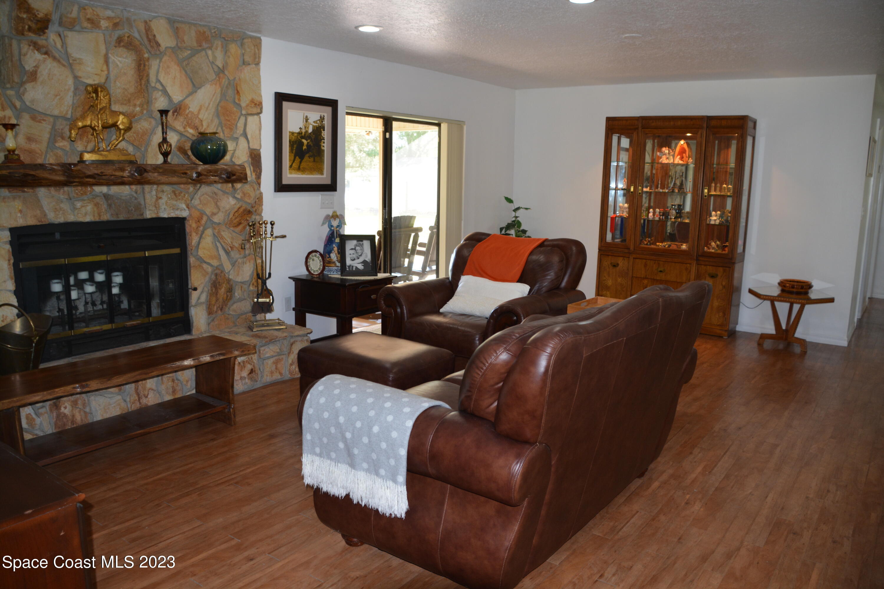 1045 Pine Island Road Merritt Island, FL 32953 - Photo 8 of 42 a living room with furniture and a fireplace