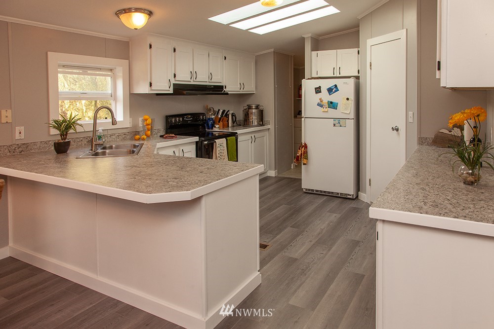 2977 East Smith Road Bellingham, WA 98226 - Photo 12 of 26 a kitchen with stainless steel appliances granite countertop a sink stove and refrigerator
