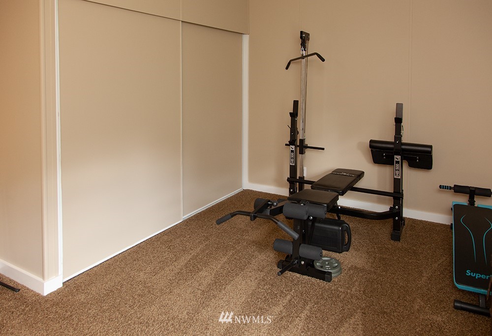 2977 East Smith Road Bellingham, WA 98226 - Photo 17 of 26 a room with gym equipment and a view of living room