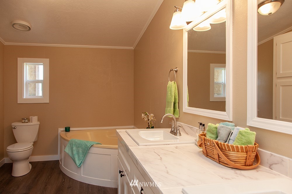 2977 East Smith Road Bellingham, WA 98226 - Photo 21 of 26 a bathroom with a toilet a sink and mirror