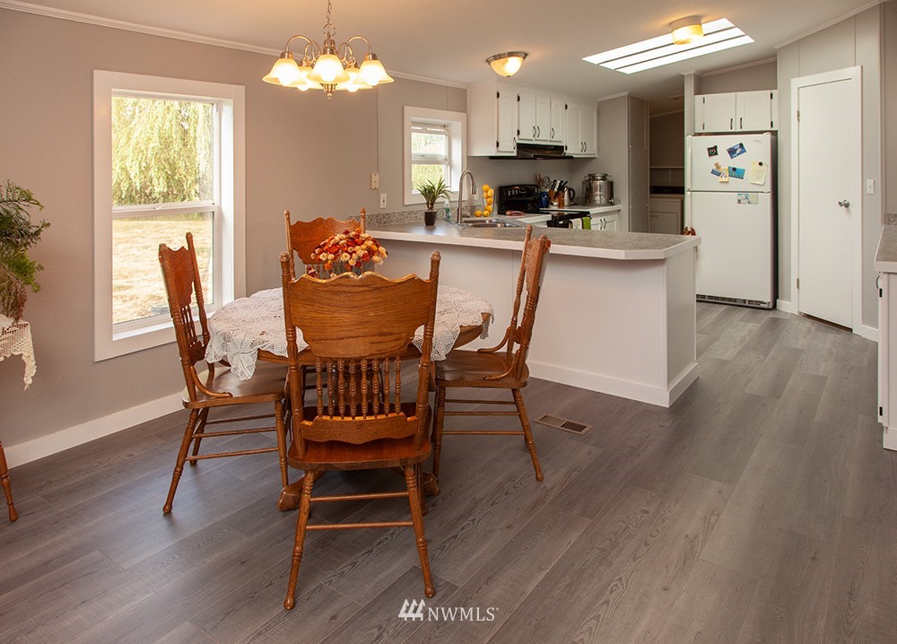 2977 East Smith Road Bellingham, WA 98226 - Photo 7 of 26 a view of a dining room with furniture and wooden floor