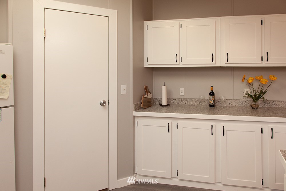 2977 East Smith Road Bellingham, WA 98226 - Photo 9 of 26 a kitchen with white cabinets and a sink