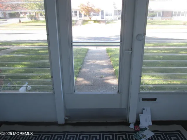 a view of a glass door with a tree in the center