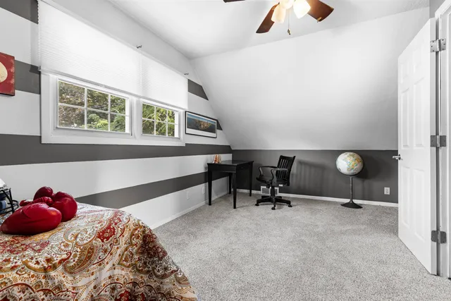 a bed room with a bed and a window