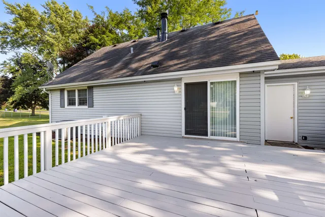 a view of a house with a wooden fence