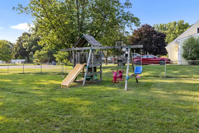 a view of a house with a big yard and sitting area