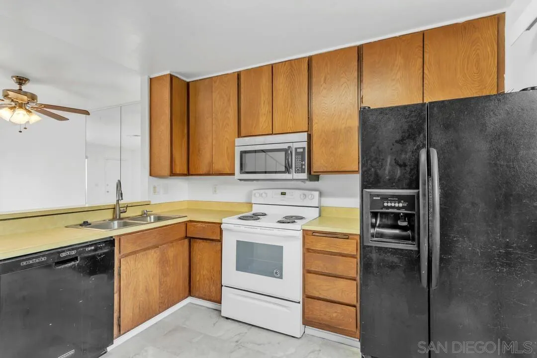 10258 Carefree Drive Santee, CA 92071 - Photo 11 of 30 a kitchen with a sink stove and microwave
