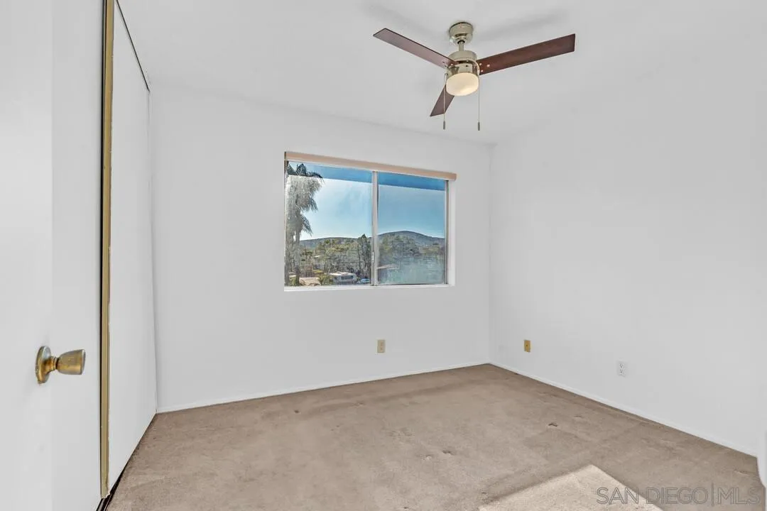 10258 Carefree Drive Santee, CA 92071 - Photo 14 of 30 an empty room with a window and a ceiling fan