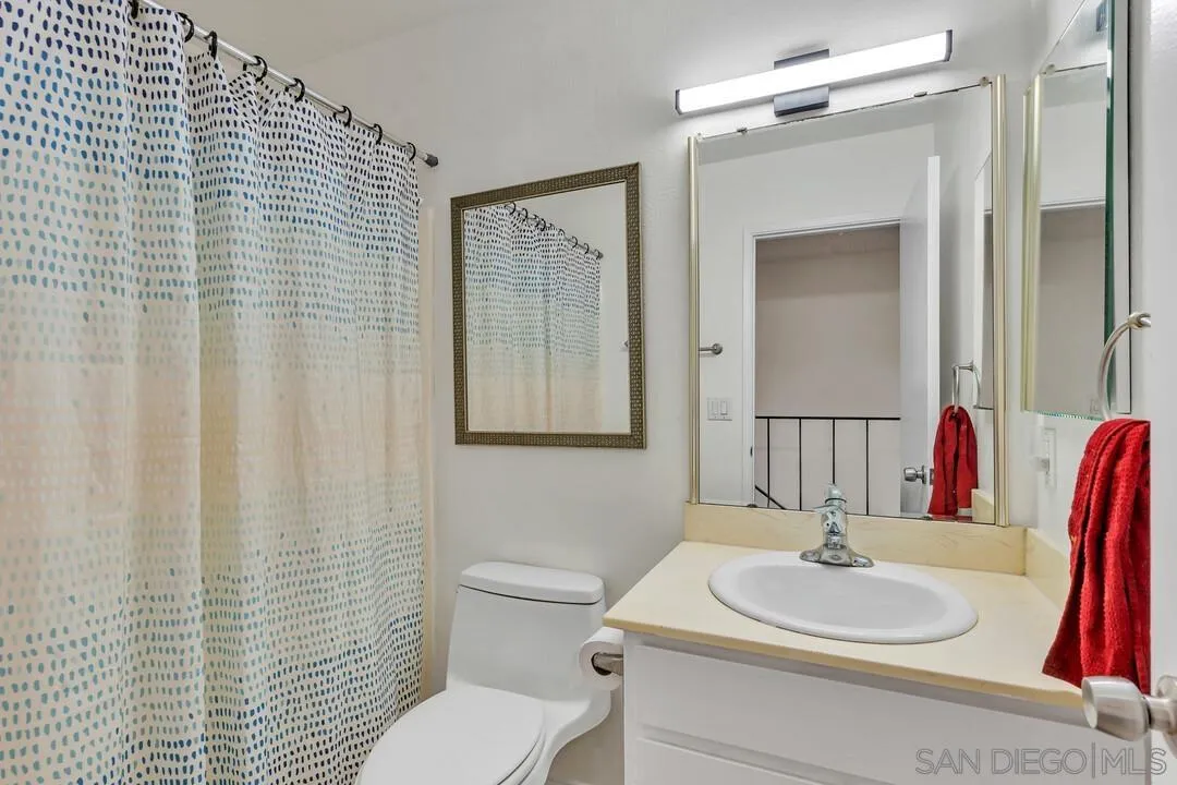 10258 Carefree Drive Santee, CA 92071 - Photo 20 of 30 a bathroom with a sink vanity mirror and toilet