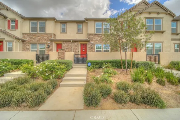 a front view of a house with a yard and trees