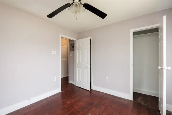 a view of an empty room with wooden floor